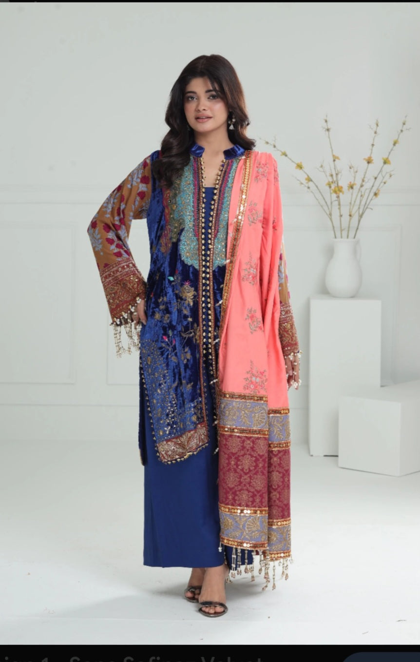 Woman wearing a traditional outfit with a blue and pink shawl on a white background